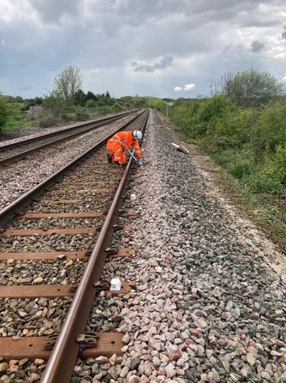 Image showing a length of the rail track, with an engineer, responding to the emergency call out, installing the Twist and Cant on the sleepers.