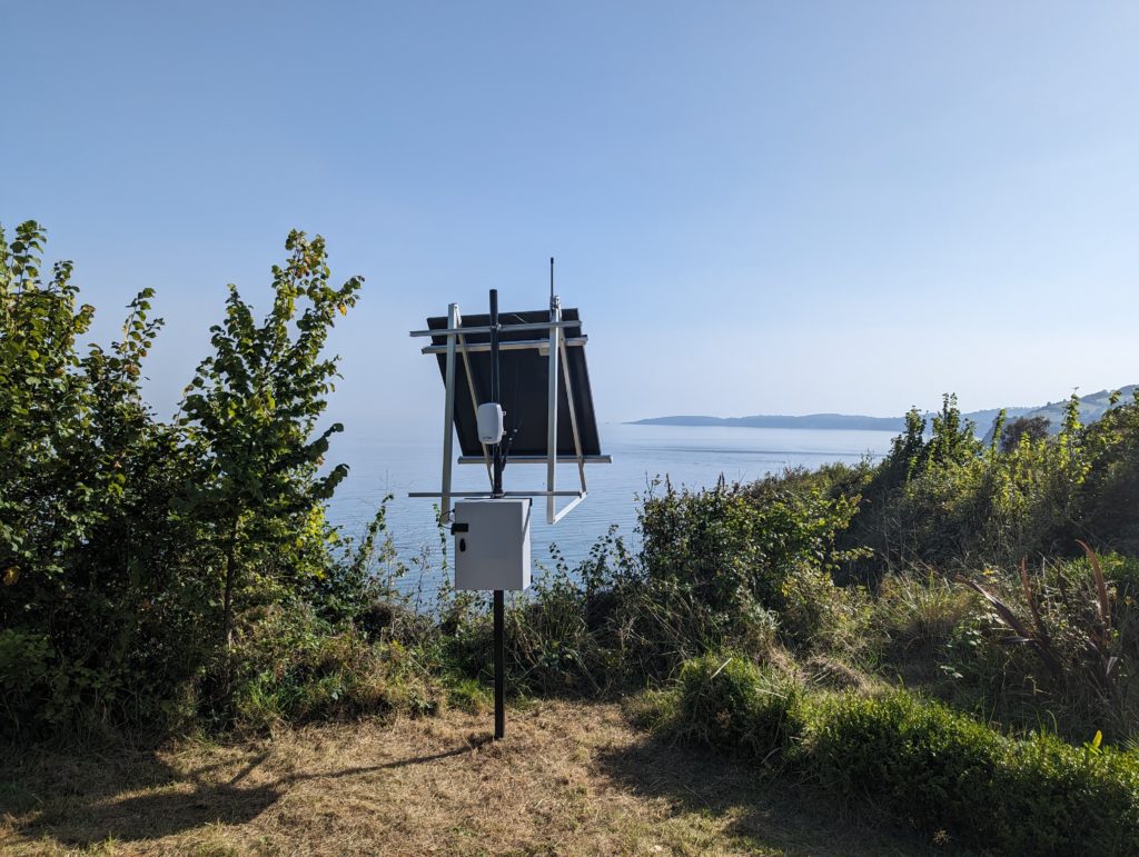 Gateway installation with solar panel on cliff top.